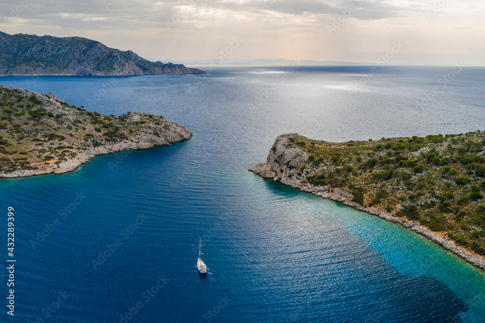 Yacht sailing near the rocky coast in Turkey. Luxury vacation at sea