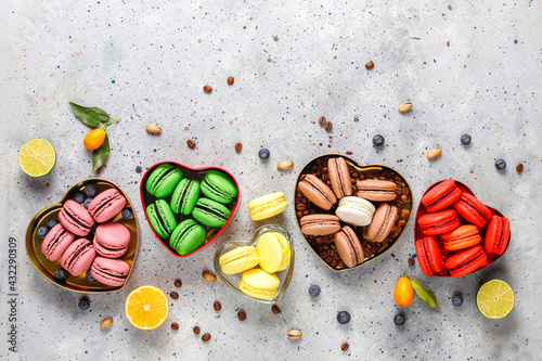 Various macaroons with pistachios,fruits,berries,coffee beans.
