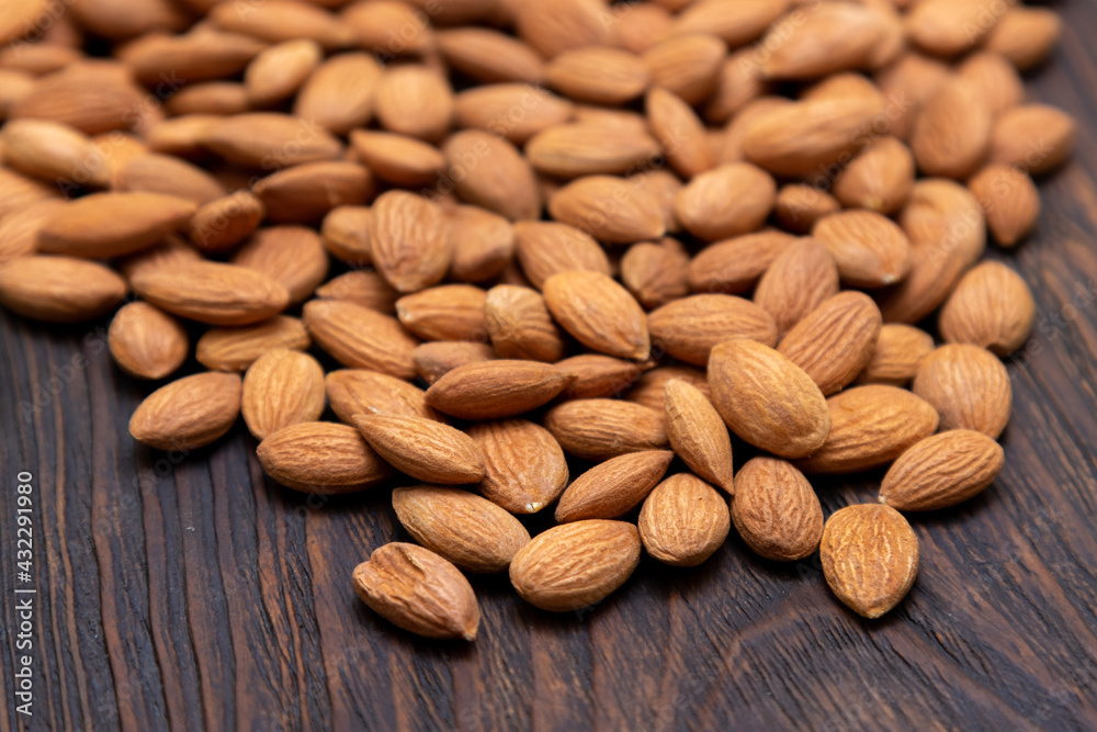 Dry nuts from an apricot kernel on a wooden table. Dry nuts from an apricot kernel on a wooden table.