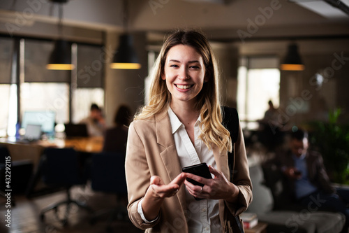 Businesswoman in office. Smiling businesswoman using the phone