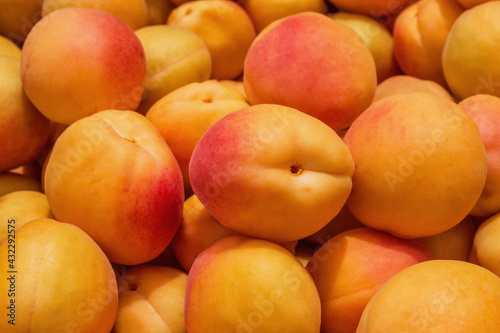 Background / texture of juicy, fresh apricots. Ripe apricots (Latin: Prunus armeniaca), close-up.