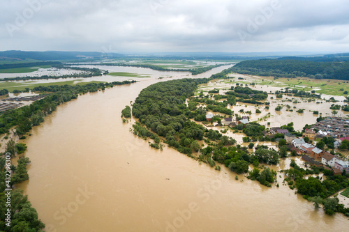 Aerial view of Dnister river with dirty water and  flooded houses in Halych town, western Ukraine. © bilanol