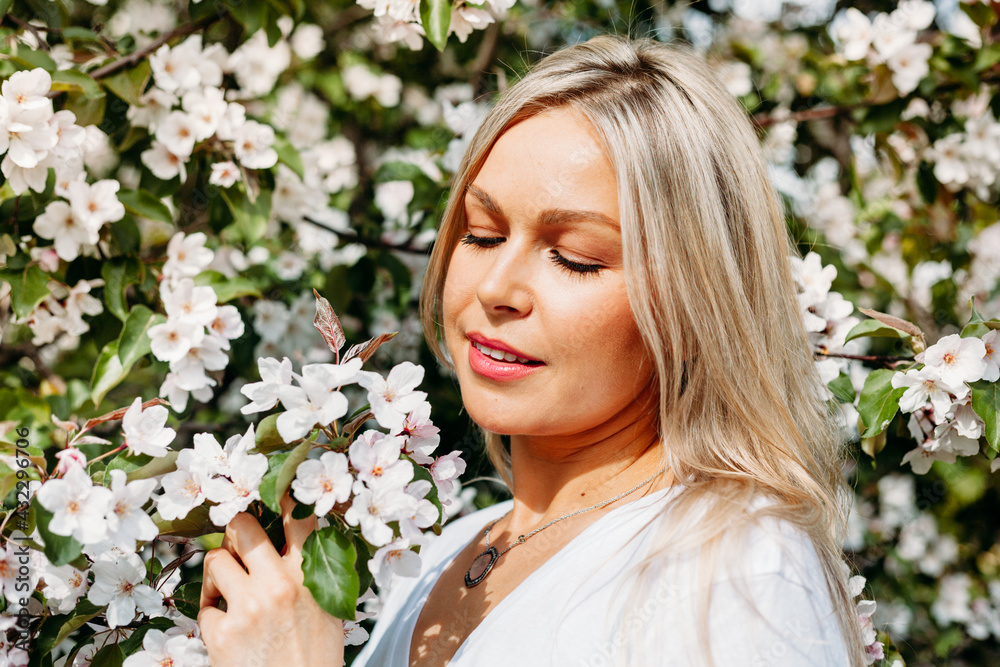 Beautiful girl with light hair, glasses, near flowering trees, Apple tree, spring, branches, flower, fashion, style, European, red Beautiful girl with light hair, glasses, near flowering trees, Apple tree, spring, branches, flower, fashion, style, European, red