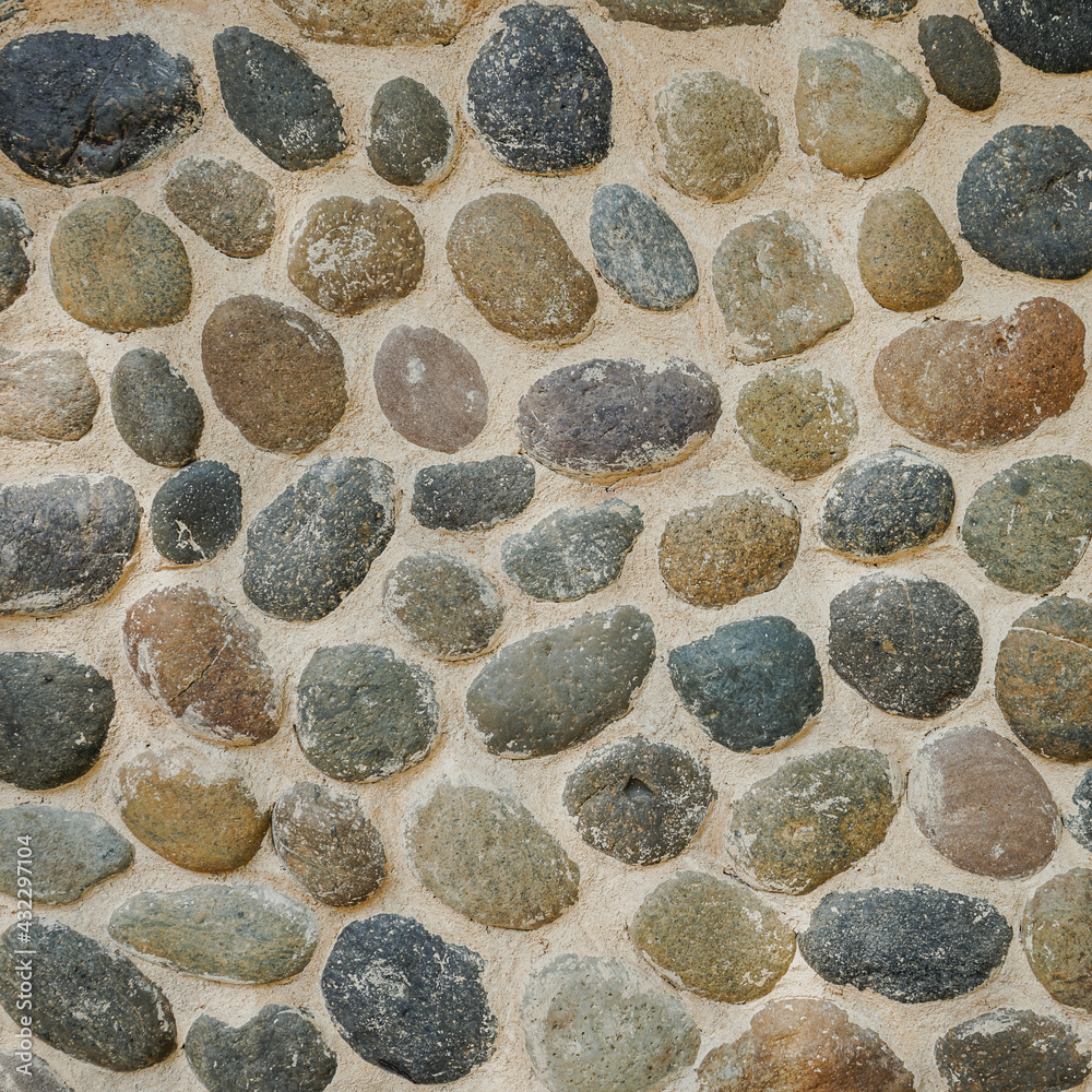 Cement wall decorate with pebble or river stone background Cement wall decorate with pebble or river stone background
