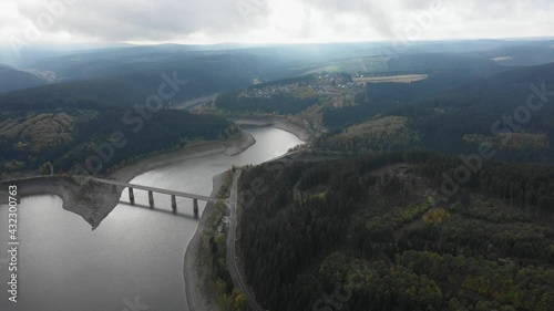 Flight over a bridge at a river between a forrest. Drone footage