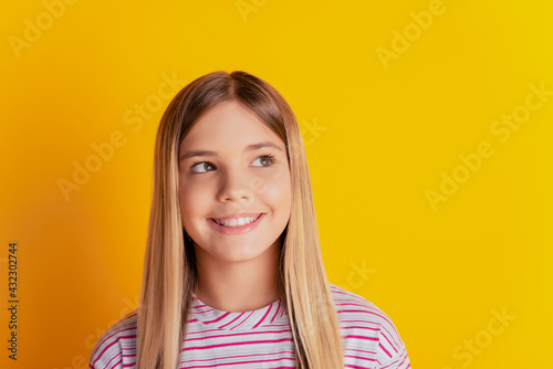 Bilde på lerret Photo of inspired kid girl think look copyspace over yellow background