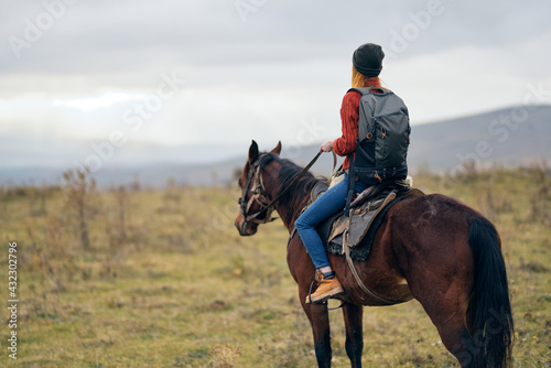 woman with backpack riding horse nature walk friendship © SHOTPRIME STUDIO