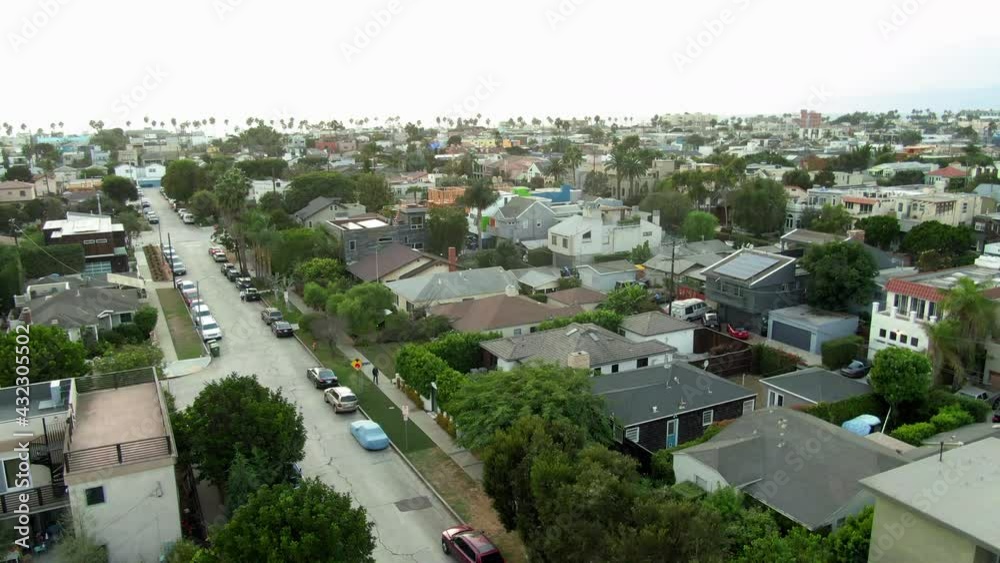 Aerial Shot Of Cars On Street Amidst Houses At Venice Canals, Drone Descending Over City Against Sky - Los Angeles, California Aerial Shot Of Cars On Street Amidst Houses At Venice Canals, Drone Descending Over City Against Sky - Los Angeles, California