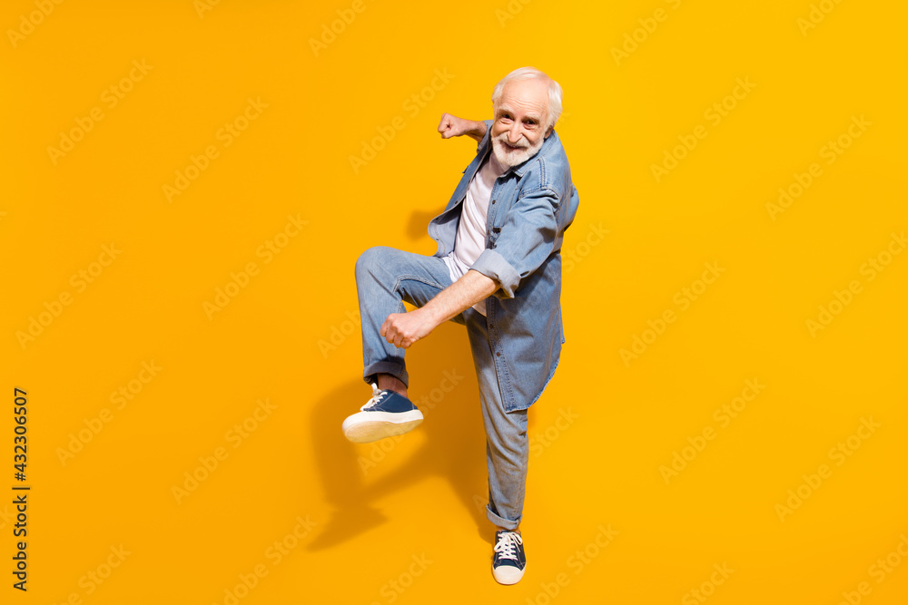 Full size portrait of excited cheerful person dancing make moves beaming smile isolated on yellow color background Full size portrait of excited cheerful person dancing make moves beaming smile isolated on yellow color background