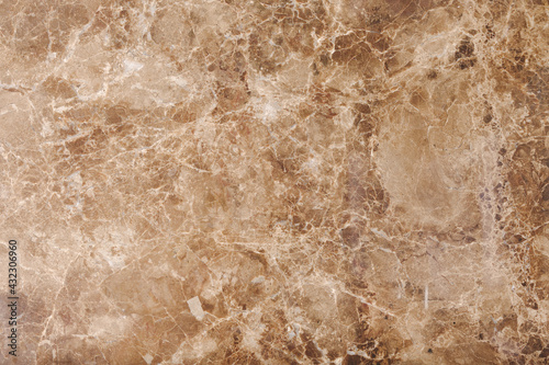 Brown and beige granite texture. Stone background. Polished natural granite slab.