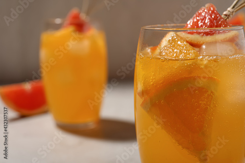 Delicious orange soda water on light background, closeup