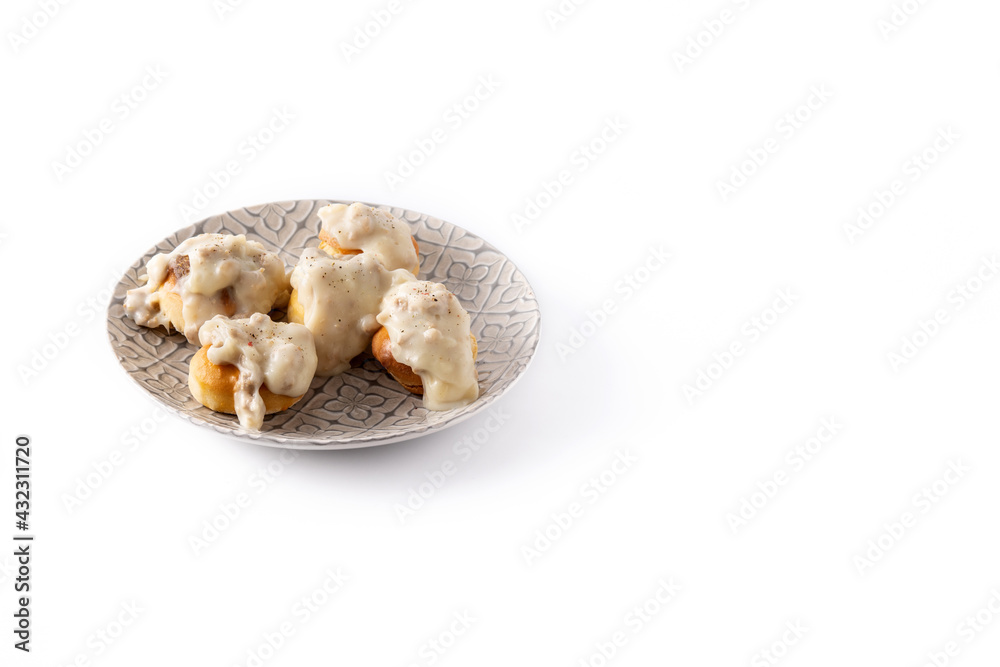 Traditional American biscuits and gravy for breakfast isolated on white background. Copy space Traditional American biscuits and gravy for breakfast isolated on white background. Copy space