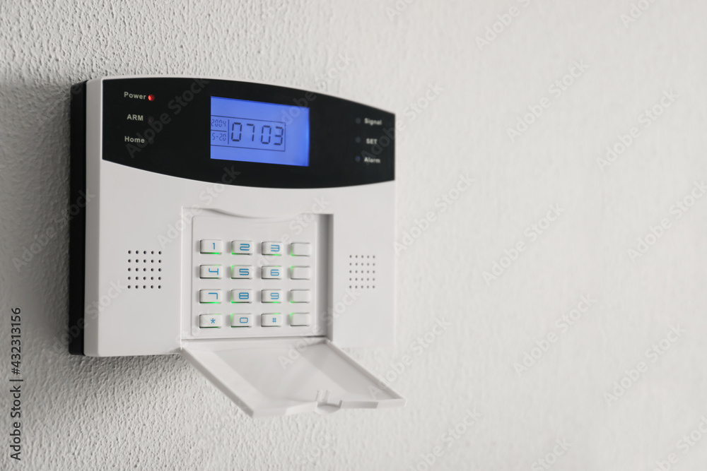 Home security system on white wall indoors, space for text Home security system on white wall indoors, space for text