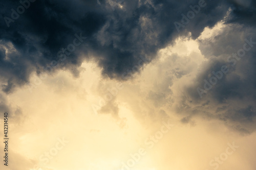 Dramatic dark grey clouds sky with storm and rain.With golden light on sunset time.