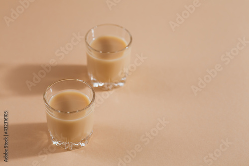 Short glasses of Irish cream Liquor or Coffee Liqueur on light background