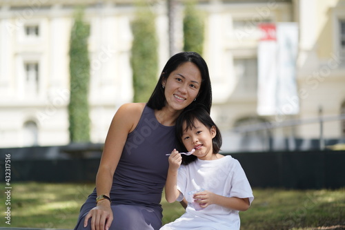 asian chinese child and mother enjoying the moment after tasting ice cream photo