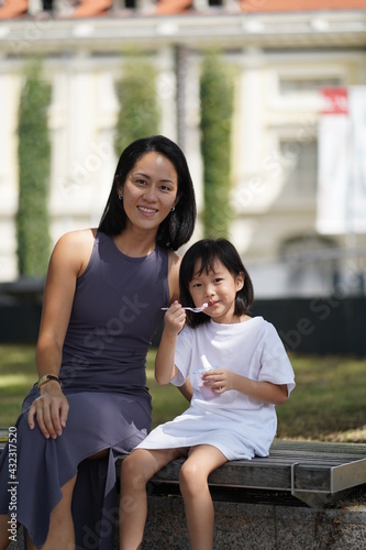 asian chinese child and mother enjoying the moment after tasting ice cream