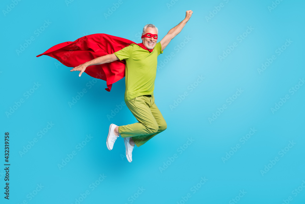 Full length body size view of handsome pensioner retired senior cheery superhero jumping having fun isolated over bright blue color background