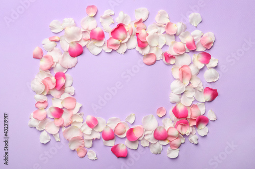 Frame of beautiful petals on lilac background, flat lay. Space for text