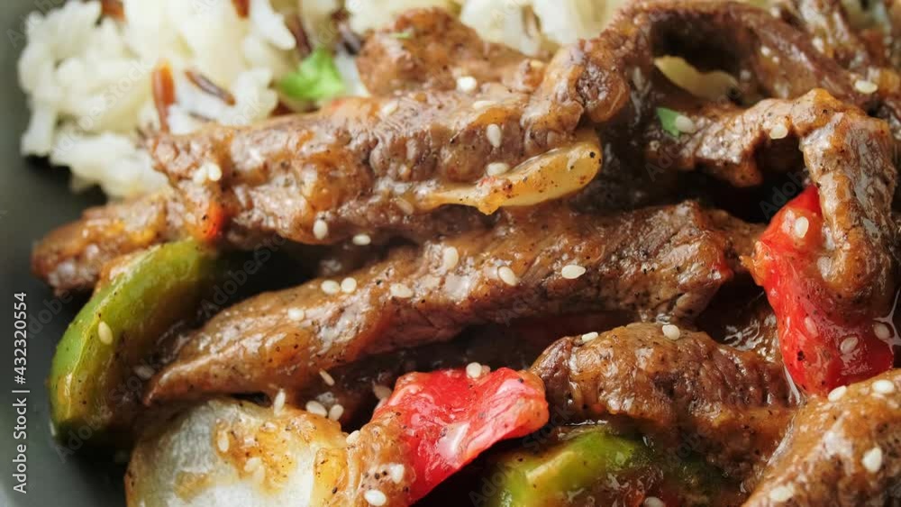 Stir fry Chinese pepper beef steak with onion, red and green bell pepper, basmati, wild rice Stir fry Chinese pepper beef steak with onion, red and green bell pepper, basmati, wild rice
