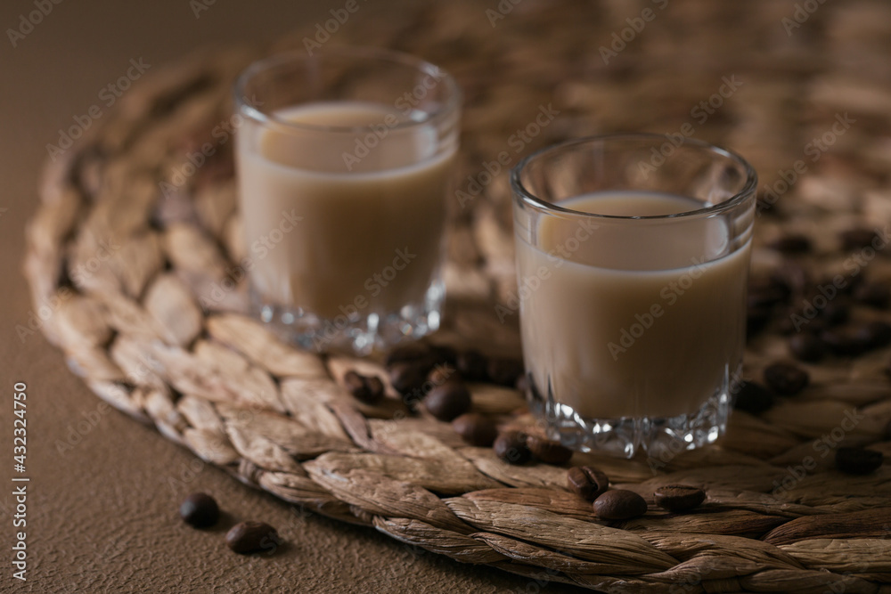 Short glasses of Irish cream Liquor or Coffee Liqueur with coffee beans. Whinter holiday decorations
