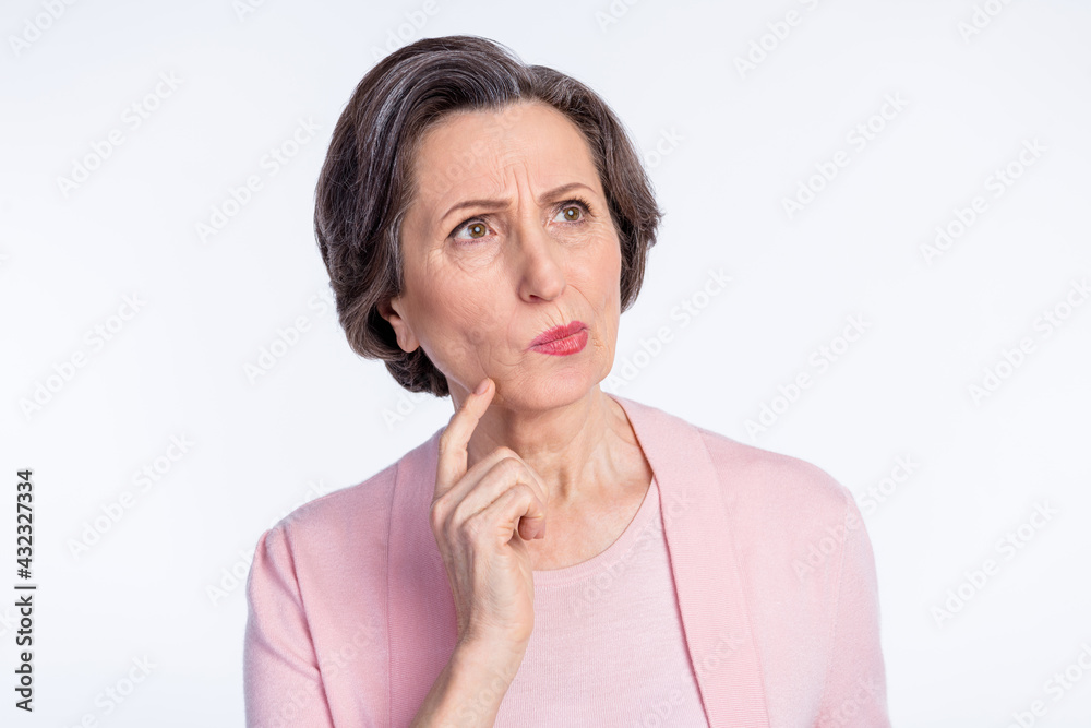 Photo of elderly woman serious finger touch chin think ponder plan look empty space isolated over grey color background Photo of elderly woman serious finger touch chin think ponder plan look empty space isolated over grey color background