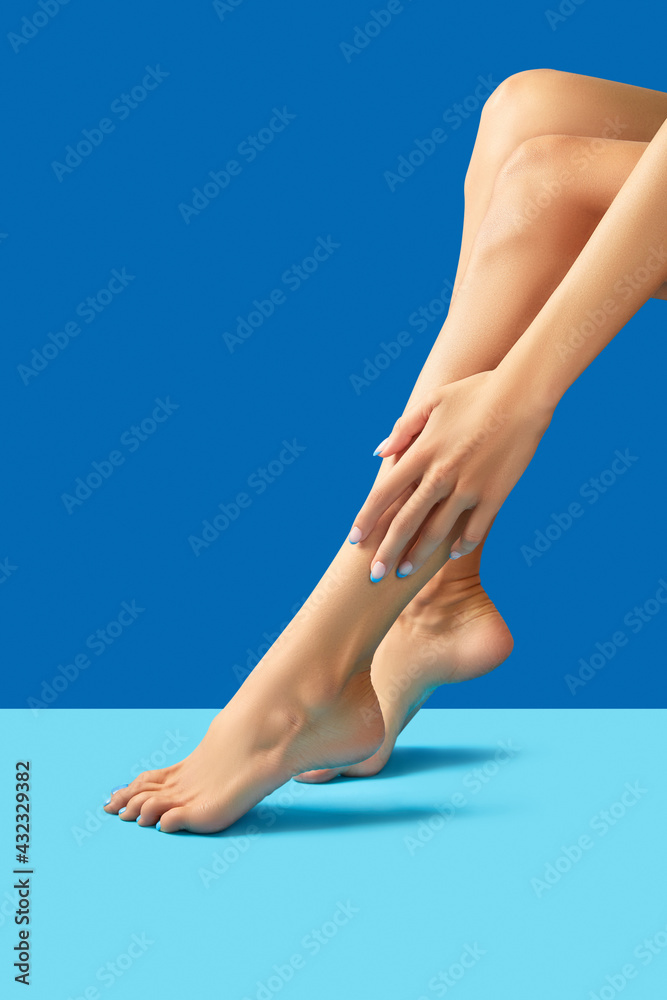 Female legs and hands with fashionable blue nail design - obrazy, fototapety, plakaty 