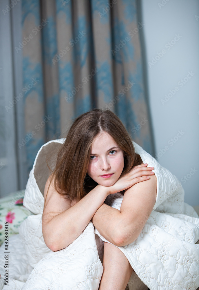 Young beautiful white woman awaking in light room. Relaxed woman lying in bed and drink tea. Good morning concept. Russian girl. Young beautiful white woman awaking in light room. Relaxed woman lying in bed and drink tea. Good morning concept. Russian girl.