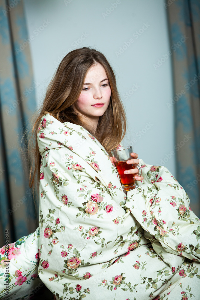 Young beautiful white woman awaking in light room. Relaxed woman lying in bed and drink tea. Good morning concept. Russian girl. Young beautiful white woman awaking in light room. Relaxed woman lying in bed and drink tea. Good morning concept. Russian girl.
