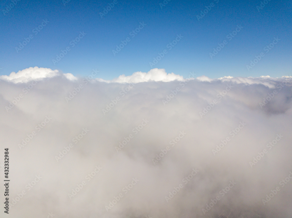 Flying in the clouds. Aerial high view.