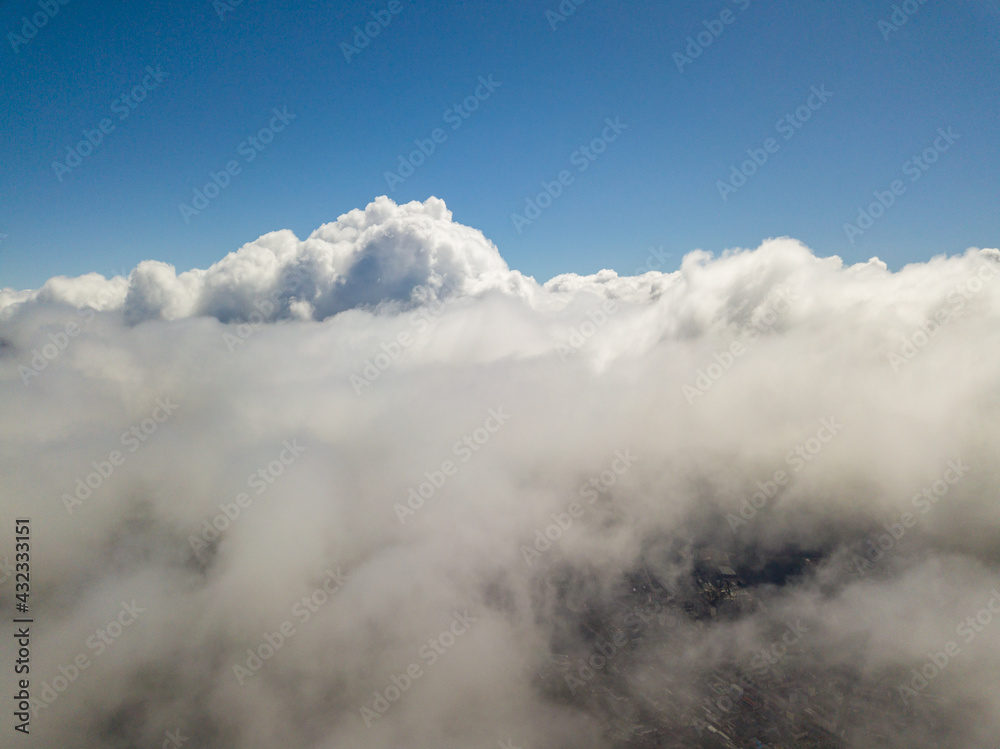 Flying in the clouds. Aerial high view.