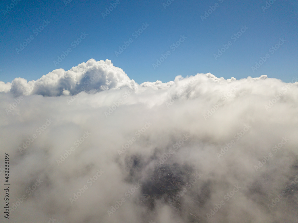 Flying in the clouds. Aerial high view.