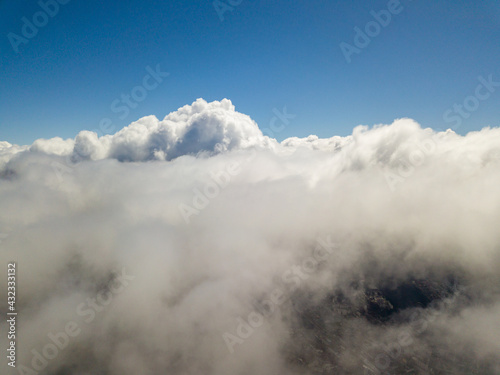 Flying in the clouds. Aerial high view.
