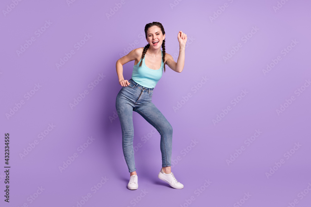 Full length body size view of lovely cheerful girl dancing having fun weekend isolated over violet purple color background Full length body size view of lovely cheerful girl dancing having fun weekend isolated over violet purple color background