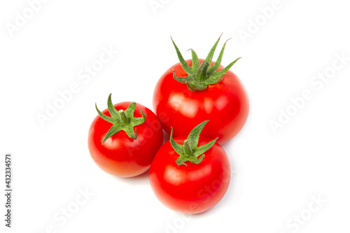 Three red tomatoes on a white isolated background. Vegetarian food concept.