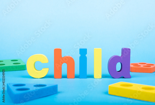 Child word written with wooden alphabets blocks on blue chart kids children background