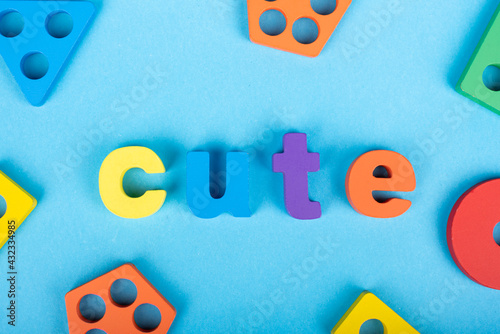 Cute word written with wooden alphabets blocks on blue chart kids children background