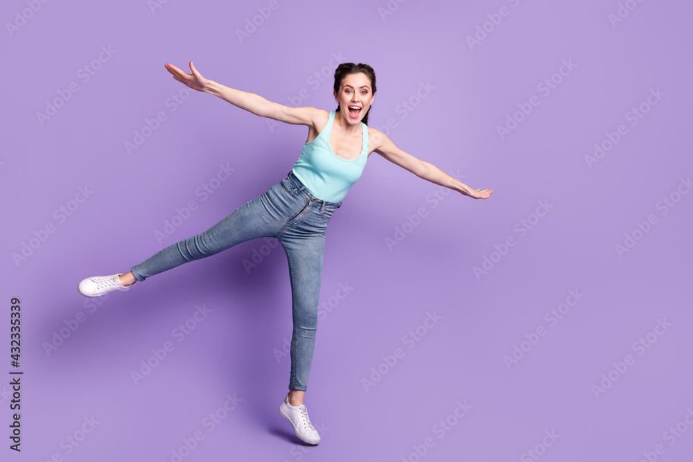 Full length body size view of pretty cheerful carefree girl flying having fun good mood isolated over violet purple color background Full length body size view of pretty cheerful carefree girl flying having fun good mood isolated over violet purple color background