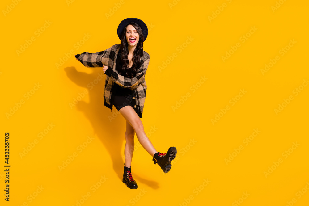 Photo of carefree lady dance wear headwear checkered shirt mini dress boots isolated yellow color background