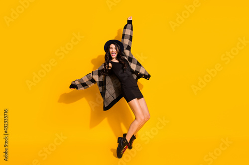 Photo of crazy energetic lady dance stand tiptoe wear hat plaid coat mini dress boots isolated yellow color background