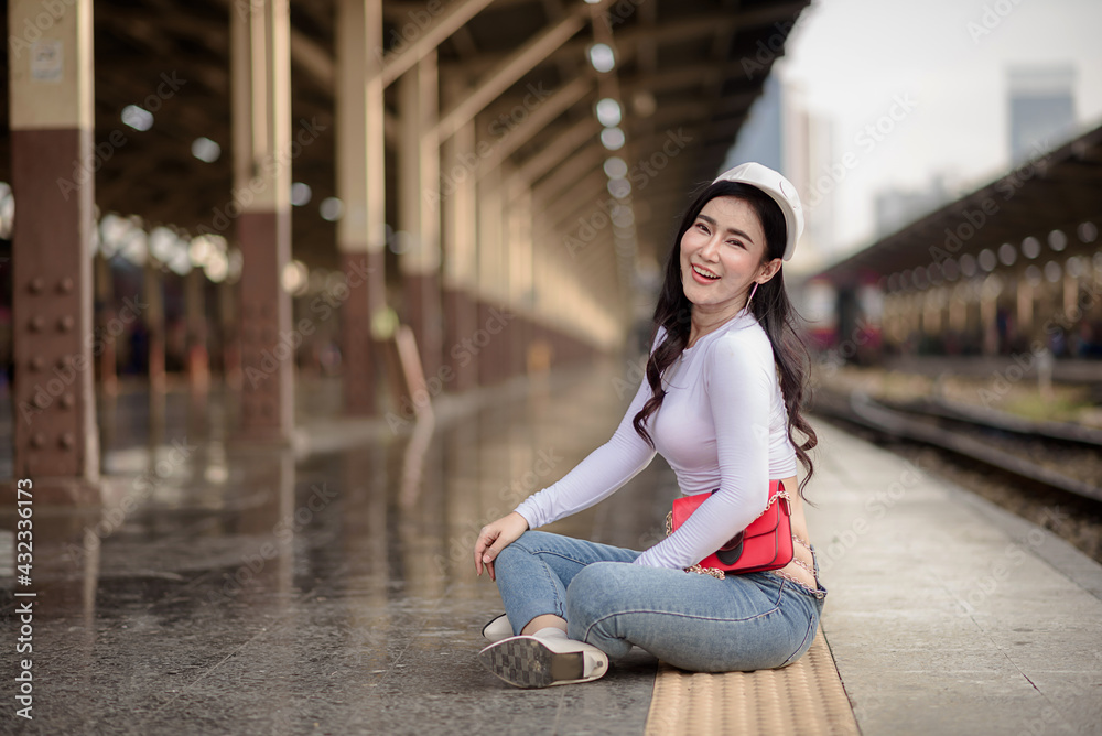 Asian female tourists are taking her to places of joy, emotional excitement, using public rail transport.