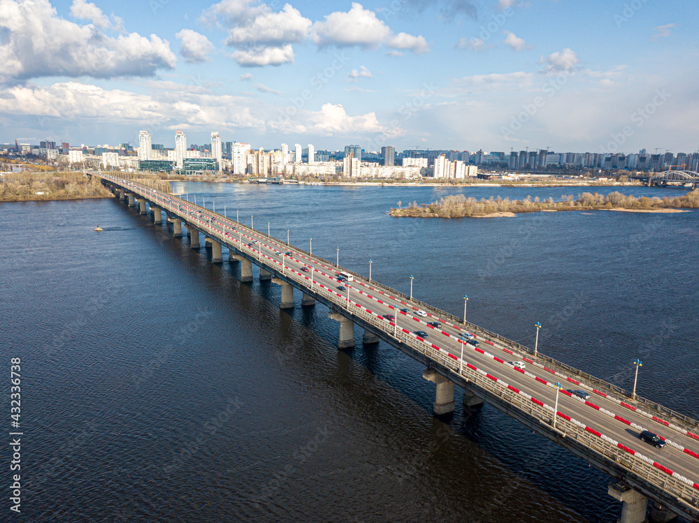 Obraz premium Automobile bridge across the Dnieper river in Kiev. Aerial drone view.
