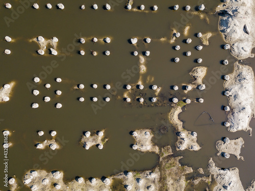 Abandoned flooded construction site. Aerial drone view.