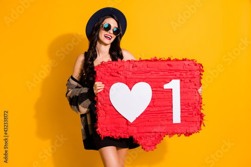 Photo of lady hold one like pinata wear glasses hat plaid coat mini dress isolated yellow color background
