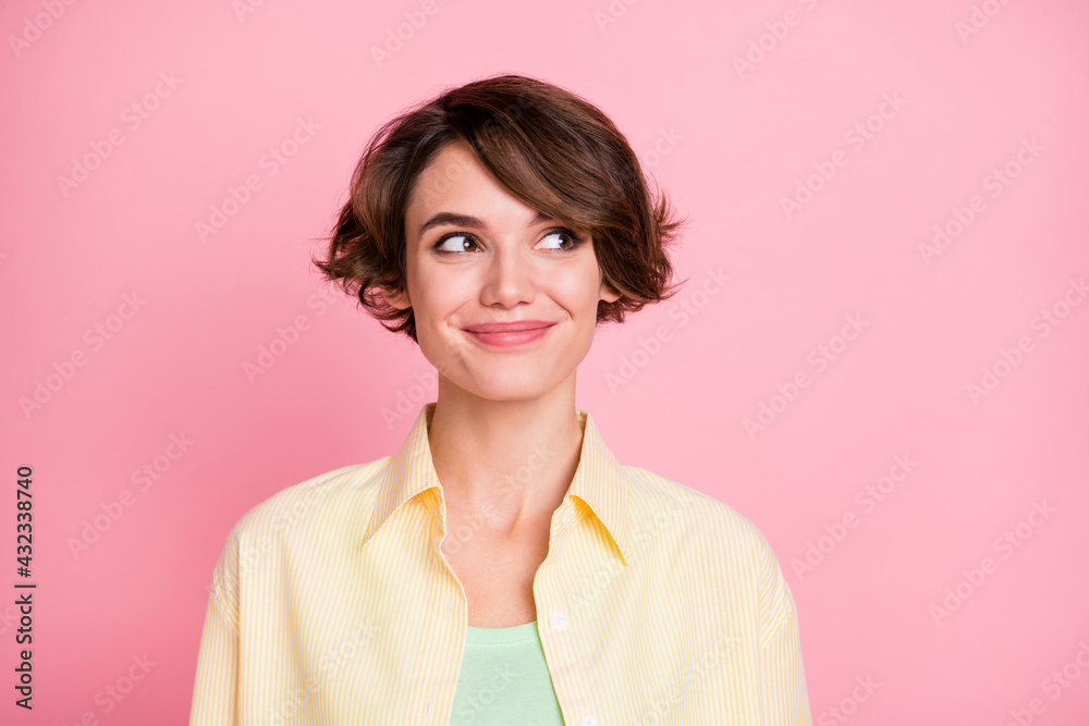 Photo of adorable charming young woman wear yellow shirt looking empty space isolated pink color background Photo of adorable charming young woman wear yellow shirt looking empty space isolated pink color background