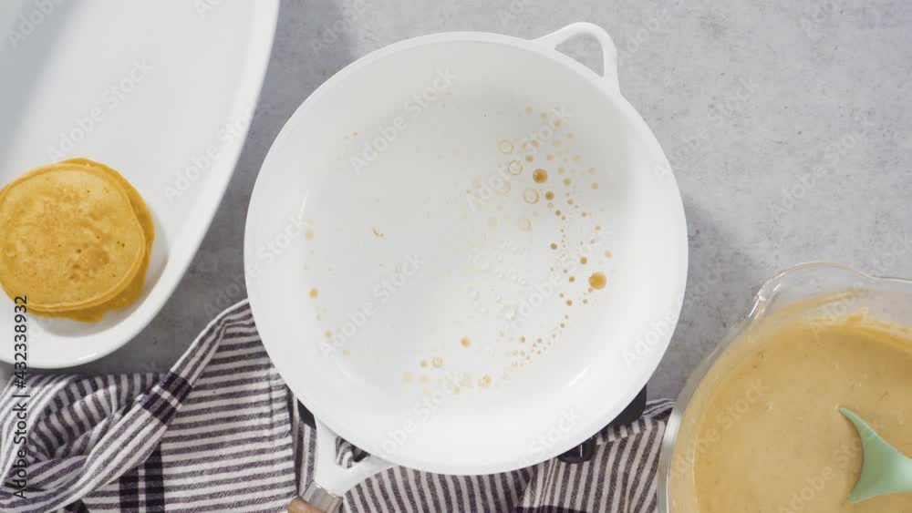 Step by step. Flat lay. Frying pumpkin pancakes batter on a white frying pan. Step by step. Flat lay. Frying pumpkin pancakes batter on a white frying pan.