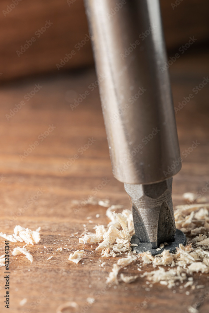 Self-tapping screw screwed into a wooden board close-up. Screw for wood Self-tapping screw screwed into a wooden board close-up. Screw for wood