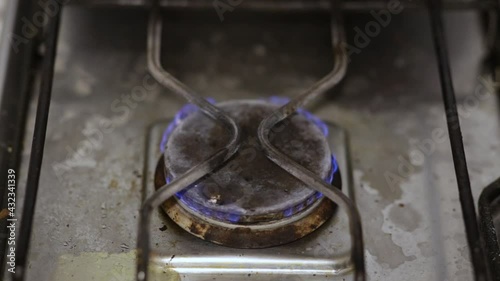 The gas burner burns with a blue flame. Cooker for cooking.