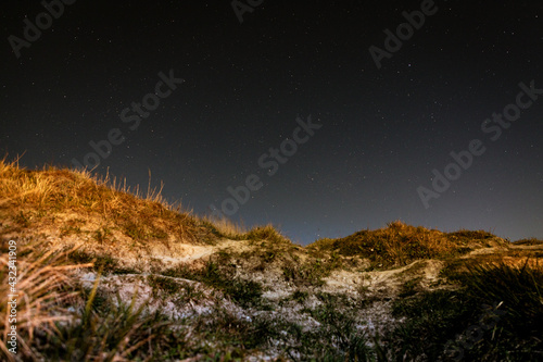 Fototapeta Naklejka Na Ścianę i Meble -  Sandy dunes with the stars at the night near Bowleaze cove on Weymouth beach, Dorset UK