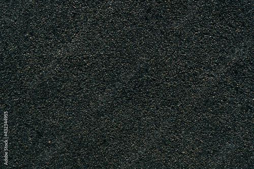 Surface texture of black rubber crumb on the playground